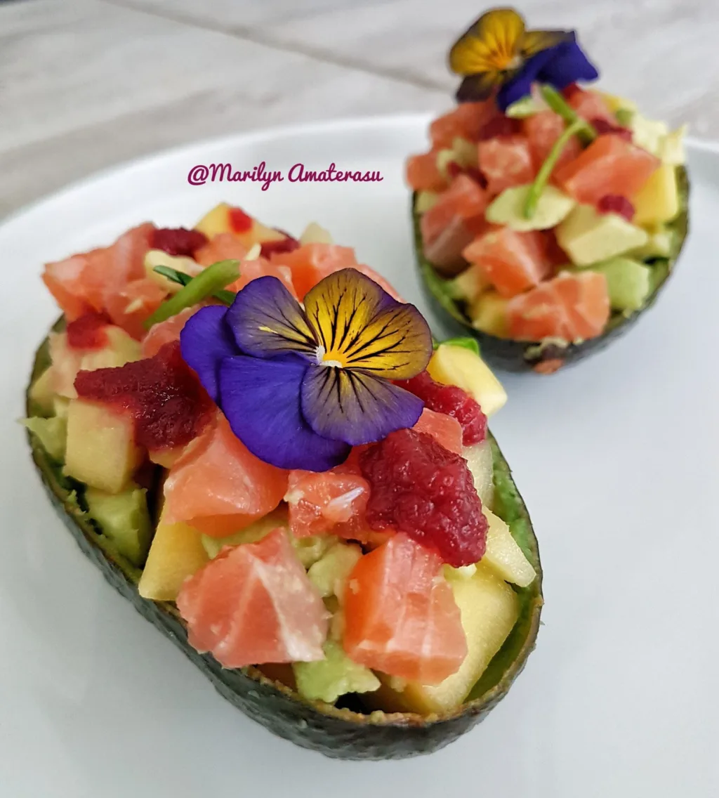 Avocado with mango and salmon in avocado bowl
